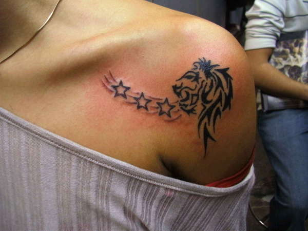 Black Tribal Leo With Stars Tattoo On Girl Left Front Shoulder