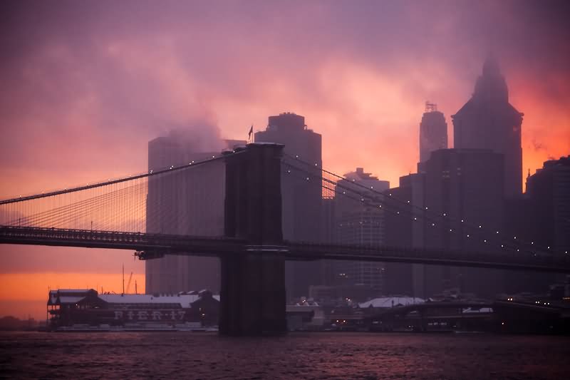 Brooklyn Bridge During Snowstorm At Sunset Time