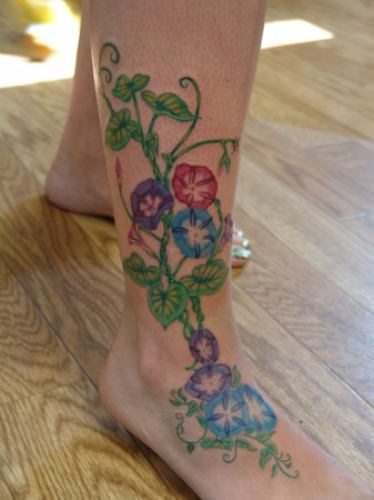 Colorful Flowers With Vine Tattoo On Foot