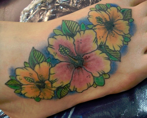 Colorful Hawaiian Flowers Tattoo On Foot