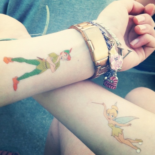 Colorful Tinkerbell And Peter Pan Tattoo On Couple Wrist