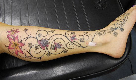 Colorful Vine Flowers Tattoo On Leg
