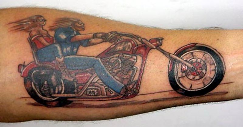 Couple Riding Motorcycle Tattoo On Left Forearm