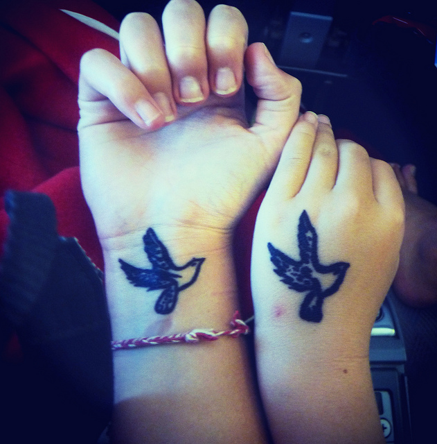 Flying Birds Friendship Tattoos On Girls Wrists
