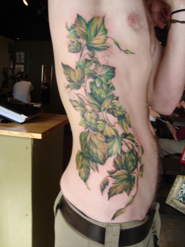 Green Ink Leaves Vine Tattoo On Man Side Rib