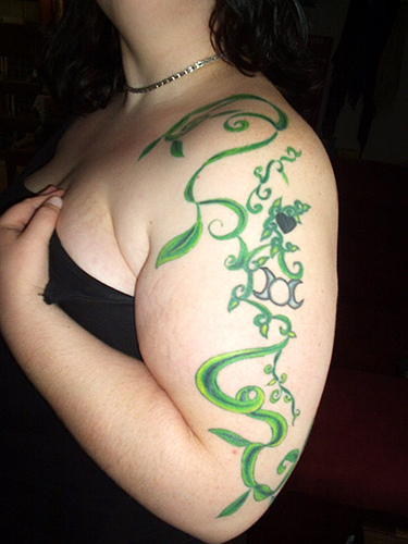 Green Ink Vine Tattoo On Girl Left Half Sleeve.