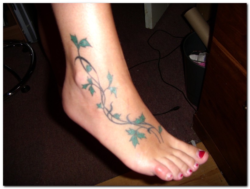 Green Leaves Vine Tattoo On Girl Foot