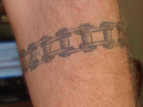 Grey Ink Motorcycle Chain Tattoo