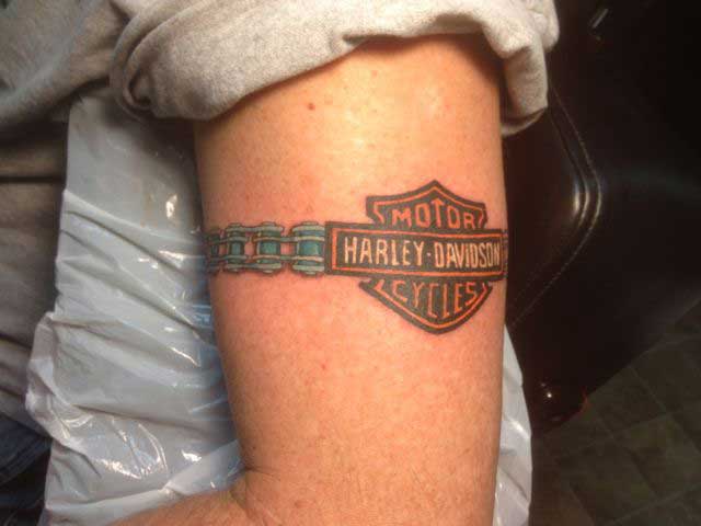 Harley Davidson Motorcycle Chain Tattoo On Left Bicep