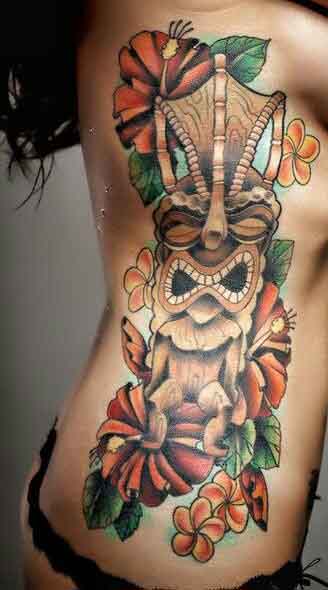 Hawaiian Tiki Mask And Flowers Tattoo On Side Rib