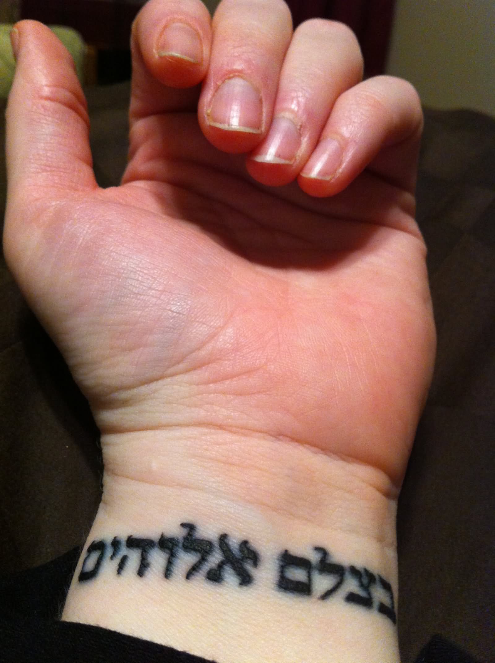 Hebrew Lettering Tattoo On Girl Left Wrist
