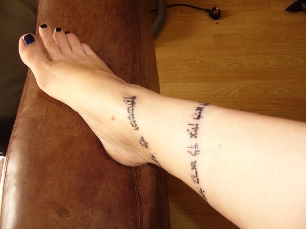 Hebrew Lettering Tattoo On Girl Leg