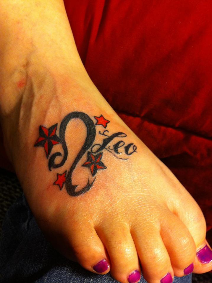 Red And Black Leo Symbol With Nautical Stars Tattoo On Girl Foot