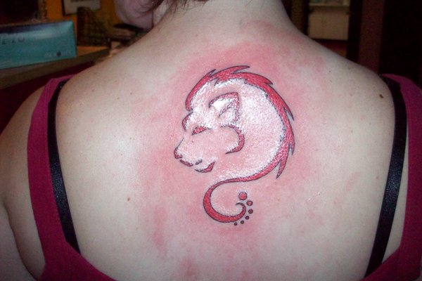 Red And White Leo Tattoo On Girl Upper Back