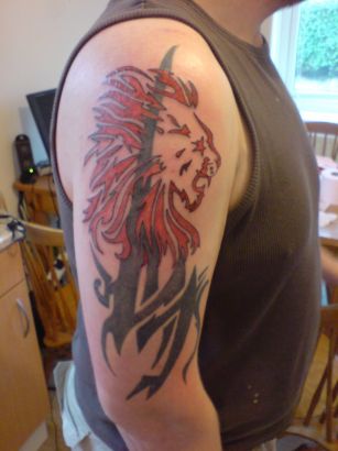 Red Tribal Leo Tattoo On Right Arm