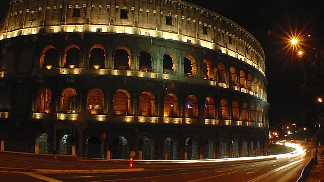 Traffic In Front Of The Colosseum At Night