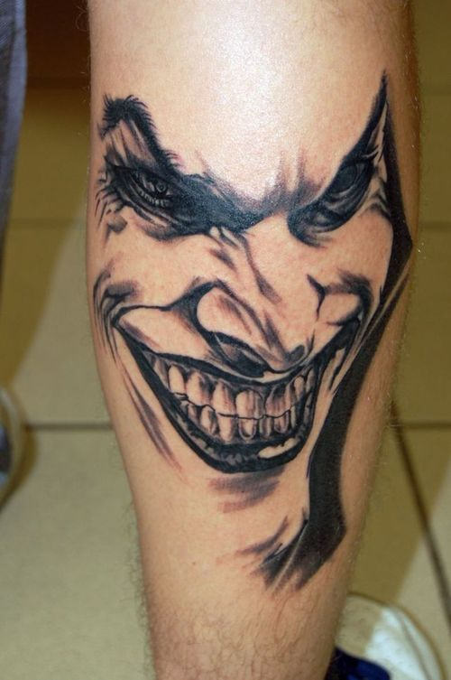 Black And Grey Joker Head Tattoo On Leg