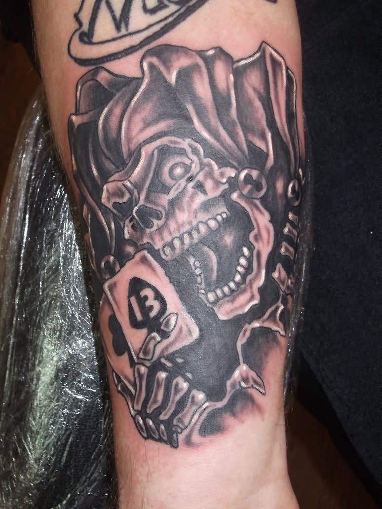 Black And Grey Joker Skull With Card Tattoo On Arm