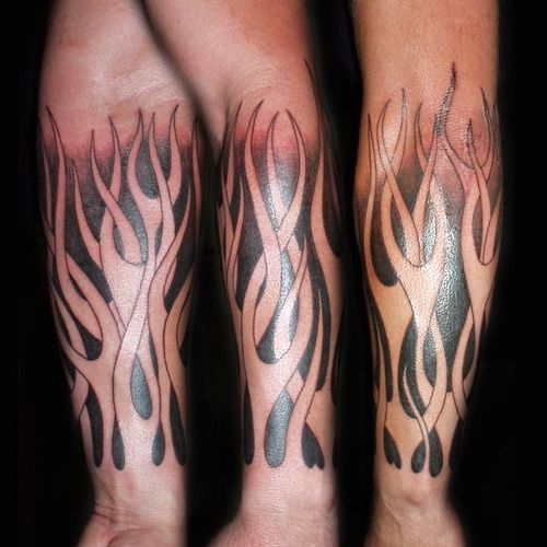 Black Ink Tribal Fire And Flame Tattoo Design For Forearm