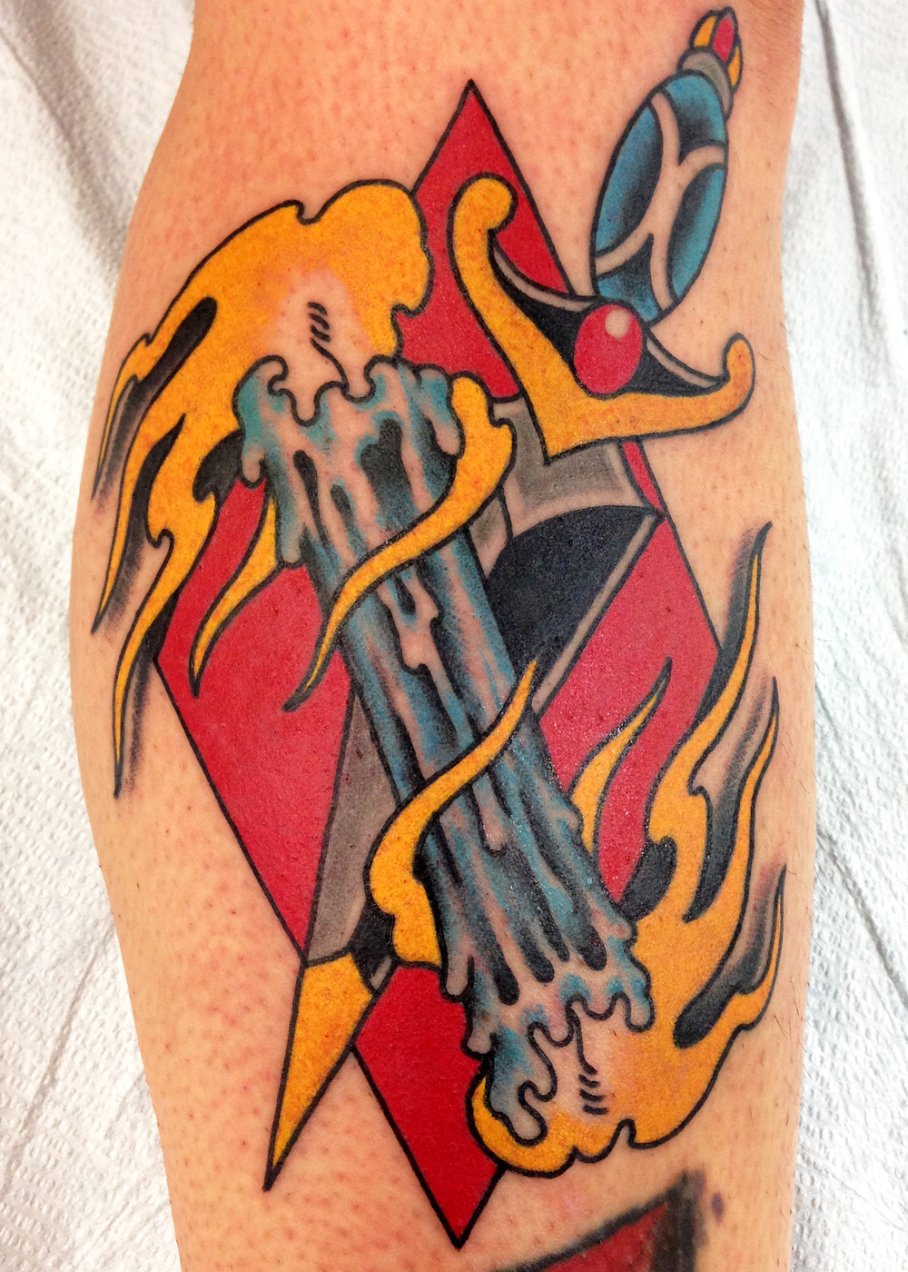 Candle burning at both ends with dagger tattoo