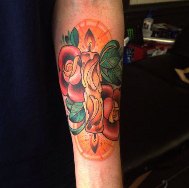Candle burning at both ends with flowers tattoo on forearm