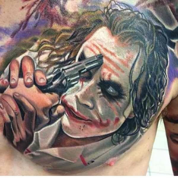 Colored Joker With Gun Tattoo On Man Chest