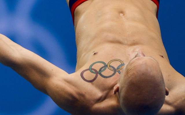 Colorful Olympic Symbol Tattoo On Man Left Front Shoulder.