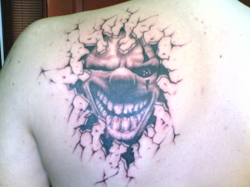 Evil Joker Tattoo On Back Shoulder