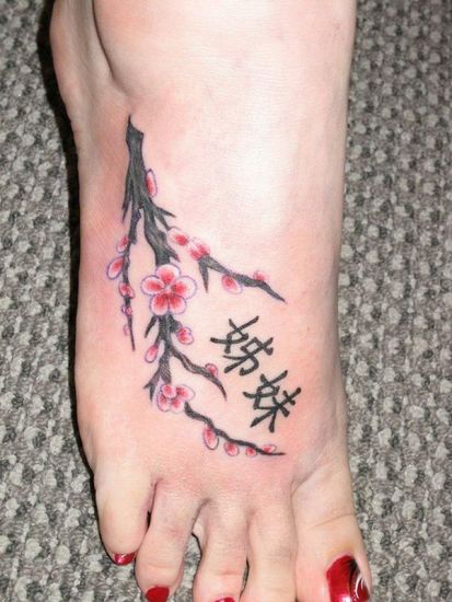 FLowers With Kanji Tattoo On Girl Foot
