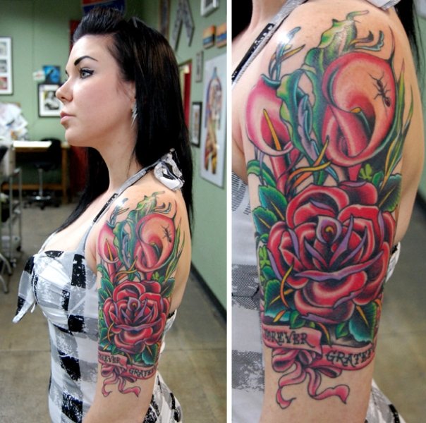 Feminine Flowers With Banner Tattoo On Girl Left Half Sleeve