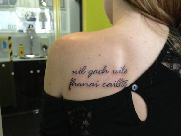 Feminine Script Tattoo On Girl Left Back Shoulder