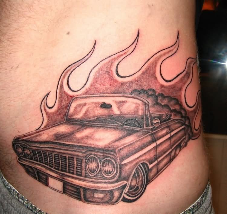 Flaming Grey Car Tattoo On Man Side Rib