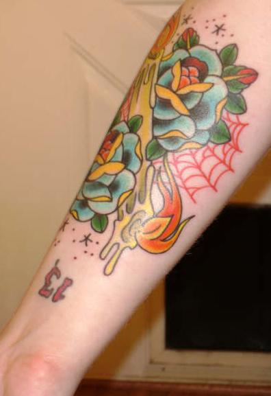 Flowered Candle Burning At Both Ends Tattoo on Forearm