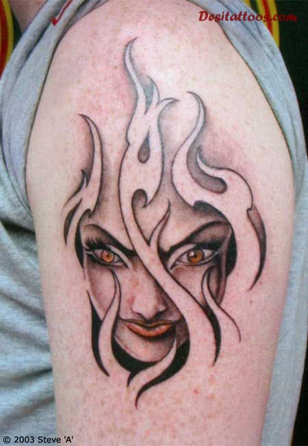 Girl Face In Fire And Flame Tattoo On Left Shoulder