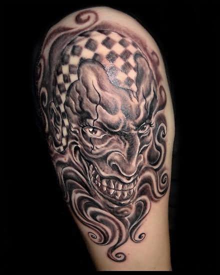 Grey Ink Evil Joker Tattoo On Shoulder