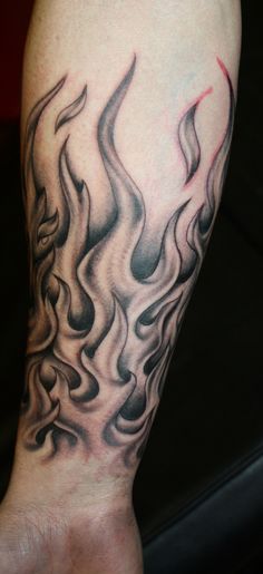 Grey Ink Fire And Flame Tattoo On Forearm By Marc Riedel