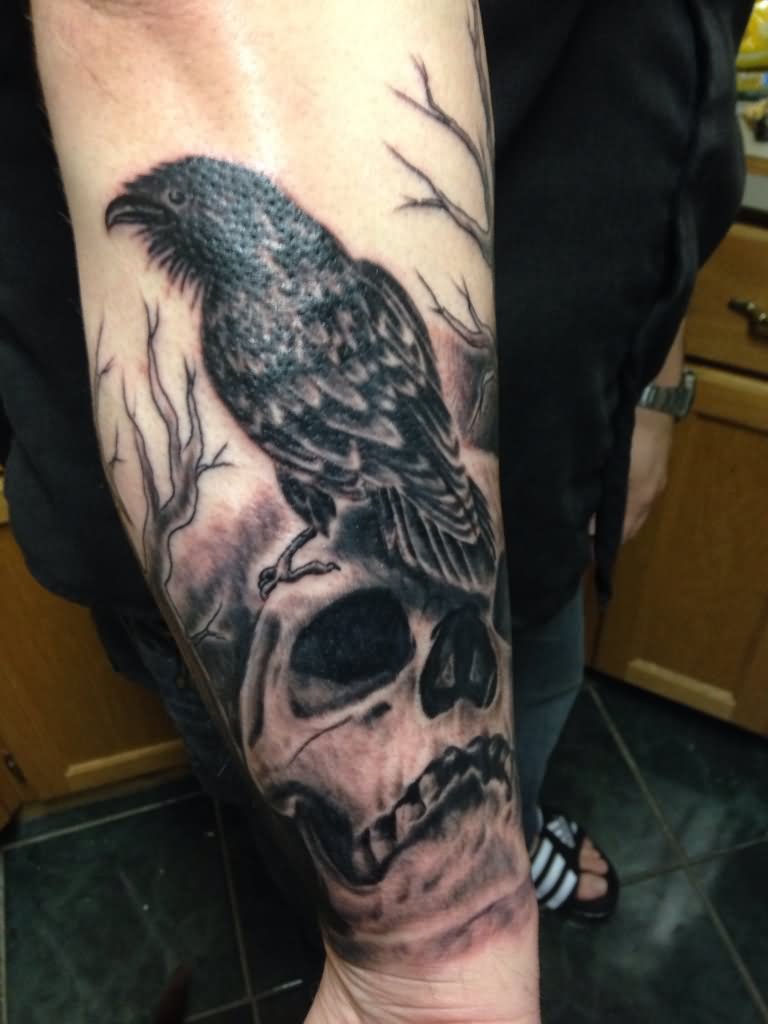 Grey Skull And Black Raven Tattoo On Arm