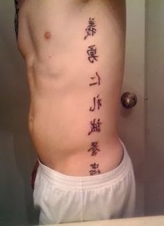 Kanji Lettering Tattoo On Man Side Rib