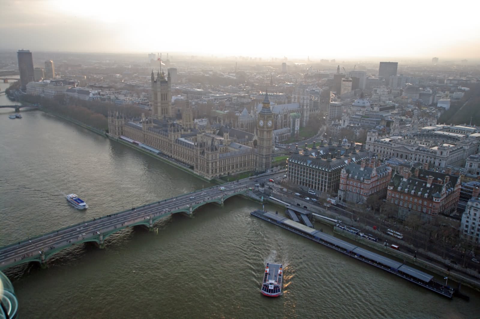 London Eye View Of Palace Of Westminster And Thames Clipper