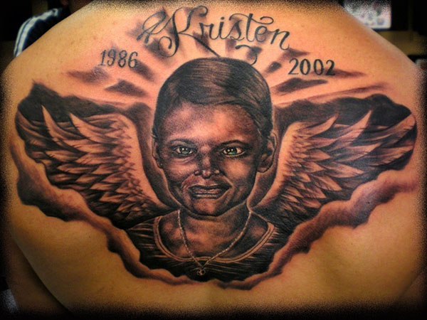 Memorial Black Ink People Face With Wings Tattoo On Upper Back