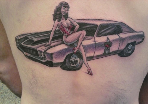 Pin Up Girl With Car Tattoo On Back