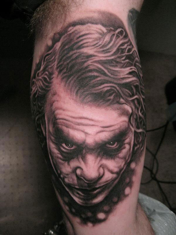 Realistic Grey Joker Head Tattoo On Half Sleeve