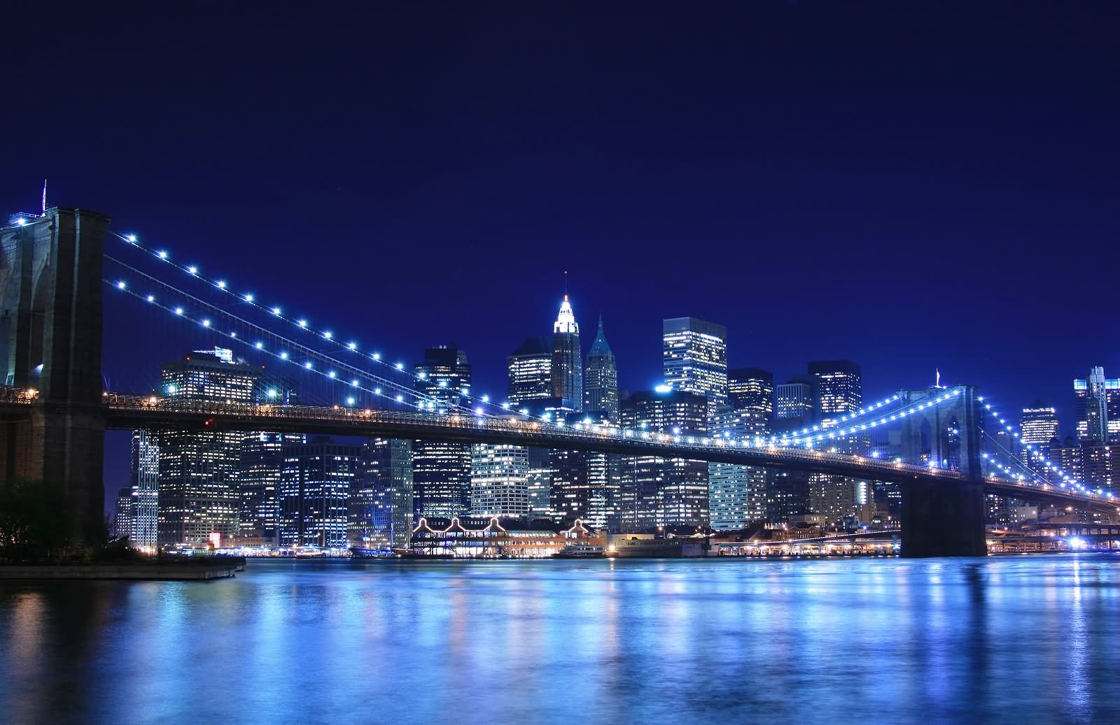 Side View Of Brooklyn Bridge And Manhattan At Night