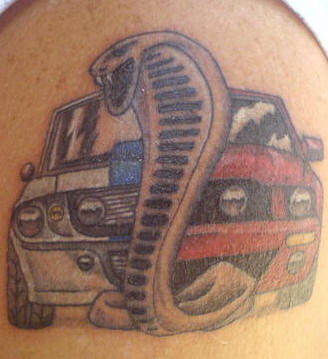 Snake And Car Tattoo On Left Shoulder
