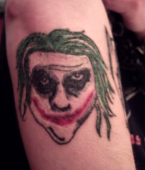 Ugly Joker Face Tattoo On Right Arm
