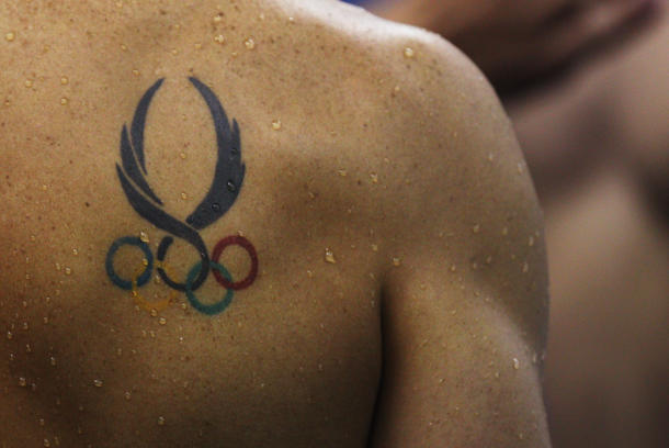 Unique Olympic Symbol Tattoo On Man Right Back Shoulder