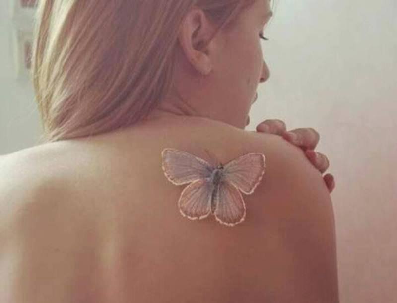 White Ink Feminine Butterfly Tattoo On Girl Right Back Shoulder