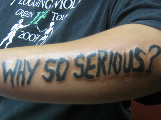 Why So Serious Joker Quote Tattoo On Left Arm.