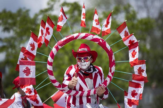 A Character On A Float Gives A Thumbs Up Along The Canada Day Parade