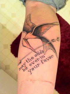 Amazing Flying Bird With Arrow And Literary Tattoo Design
